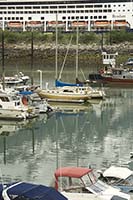 Small boat marina with another cruise ship in the background