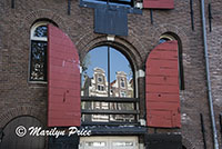 Former warehouses reflected in the windows of other warehouses along Prinsen Gracht, Amsterdam, Netherlands