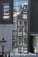 Former warehouses reflected in the windows of the Anne Frank house along Prinsen Gracht, Amsterdam, Netherlands