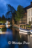 Buildings and boats reflected in a canal at twilight, Bruges, Belgium