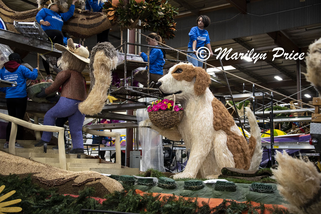 Dog with basket of flowers on Wescom float, Float construction barn, Los Angeles, CA