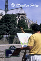 Painter and the rear facade of the Cathedral of Notre Dame de Paris, Paris, France