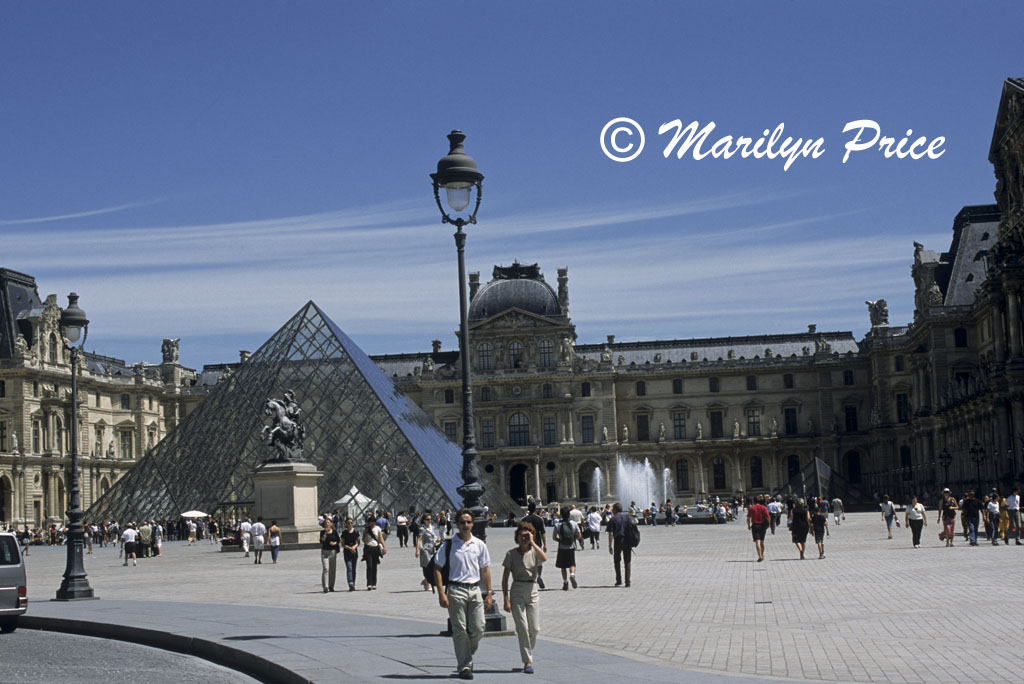 The horseshoe building of the Louvre, with its glass pyramid entrance and large fountain, Paris, France