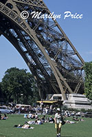 Walking and resting under the base of the Eiffel Tower, Paris, France