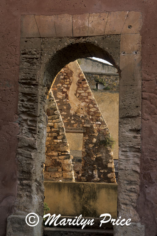 Church buttresses through an arch, Rousillon, France