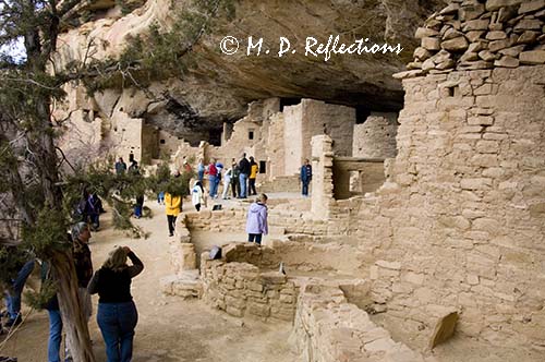 Tourists visit Spruce Tree House, Mesa Verde National Park, CO