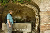 Carl collects water from still operating aqueducts, Rome, Italy