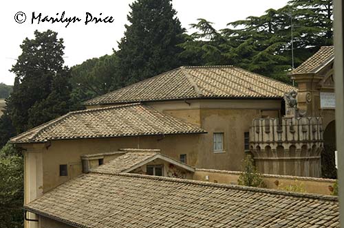 Looking out a window of the Vatican Museum into the gardens and rooftops, Vatican City