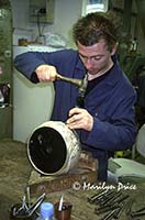 Hammering a design into a silver bowl, Florence, Italy