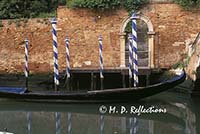 Old gondola moored to a pole, Venice, Italy