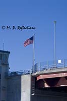 American flag flies high over a bridge in Portland, ME