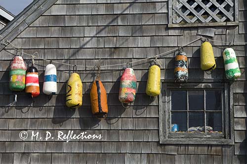 Lobster buoys displayed on a wall, Peggy's Cove, Nova Scotia