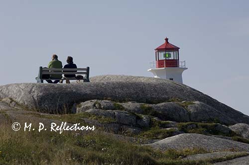 Visitors relax at the Light at Peggy's Point, Peggy's Cove, Nova Scotia