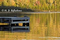 Dock and reflected autumn colors, Nahmakanta Lake, ME