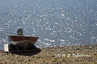 Motor boat and lake sparkles, Nahmakanta Lake, ME