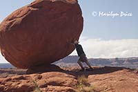 Carl pretends to hold up a balanced rock, Potash Jeep trail, Canyonlands National Park, UT