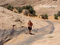 Jenny scouts one of the obstacles on Hell's Revenge, near Moab, UT