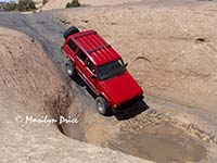 Jim takes his jeep through a 'hot tub', Hell's Revenge, near Moab, UT