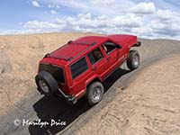 Jim takes his jeep through a 'hot tub', Hell's Revenge, near Moab, UT