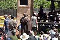 A monk takes pictures with his cell phone of the man playing the carillon, Colorado Renaissance Festival, Larkspur, CO