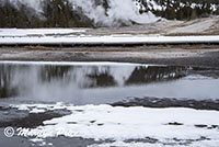 Old Faithful steaming and its reflection, Upper Geyser Basin, Yellowstone National Park, WY