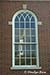 Window of Kingsport Utilities Building with reflection of First Baptist Church, Kingsport, TN